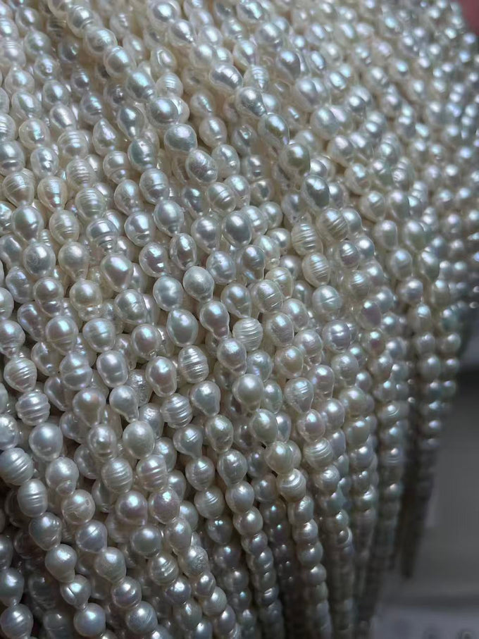 2–2.5 mm White Ribbed Rice Pearl Strand · 3A — supplied lot image 1