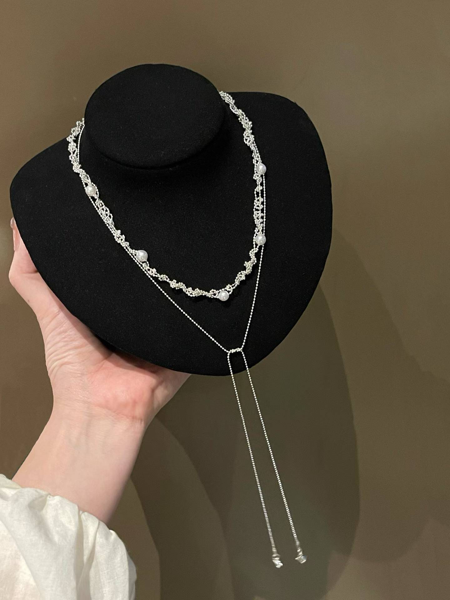 Layered freshwater pearl necklace on a black display bust