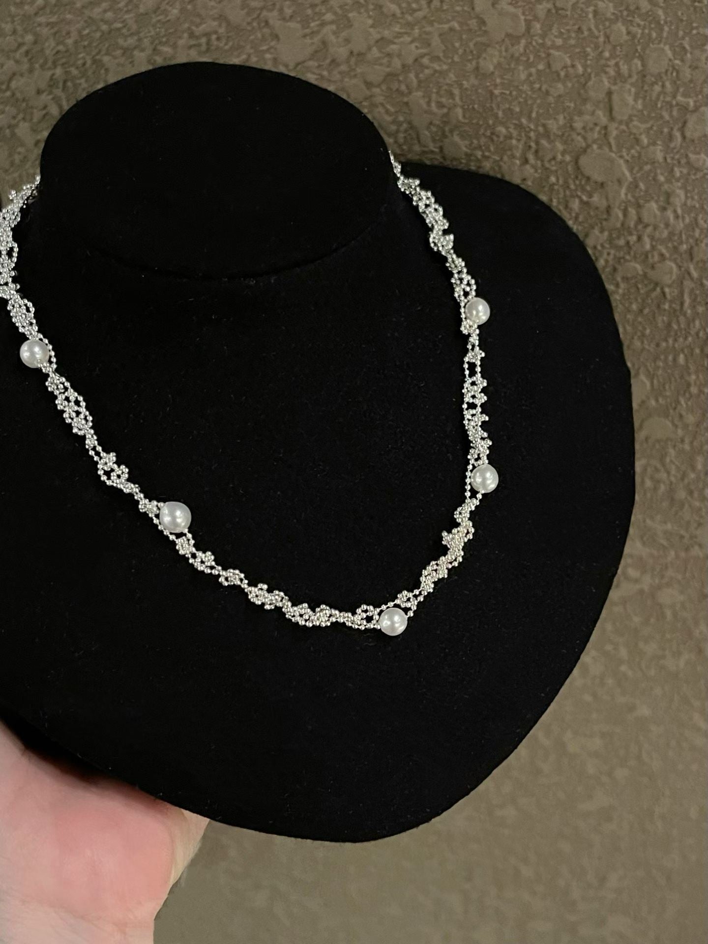 Freshwater pearl necklace detail on a black display bust