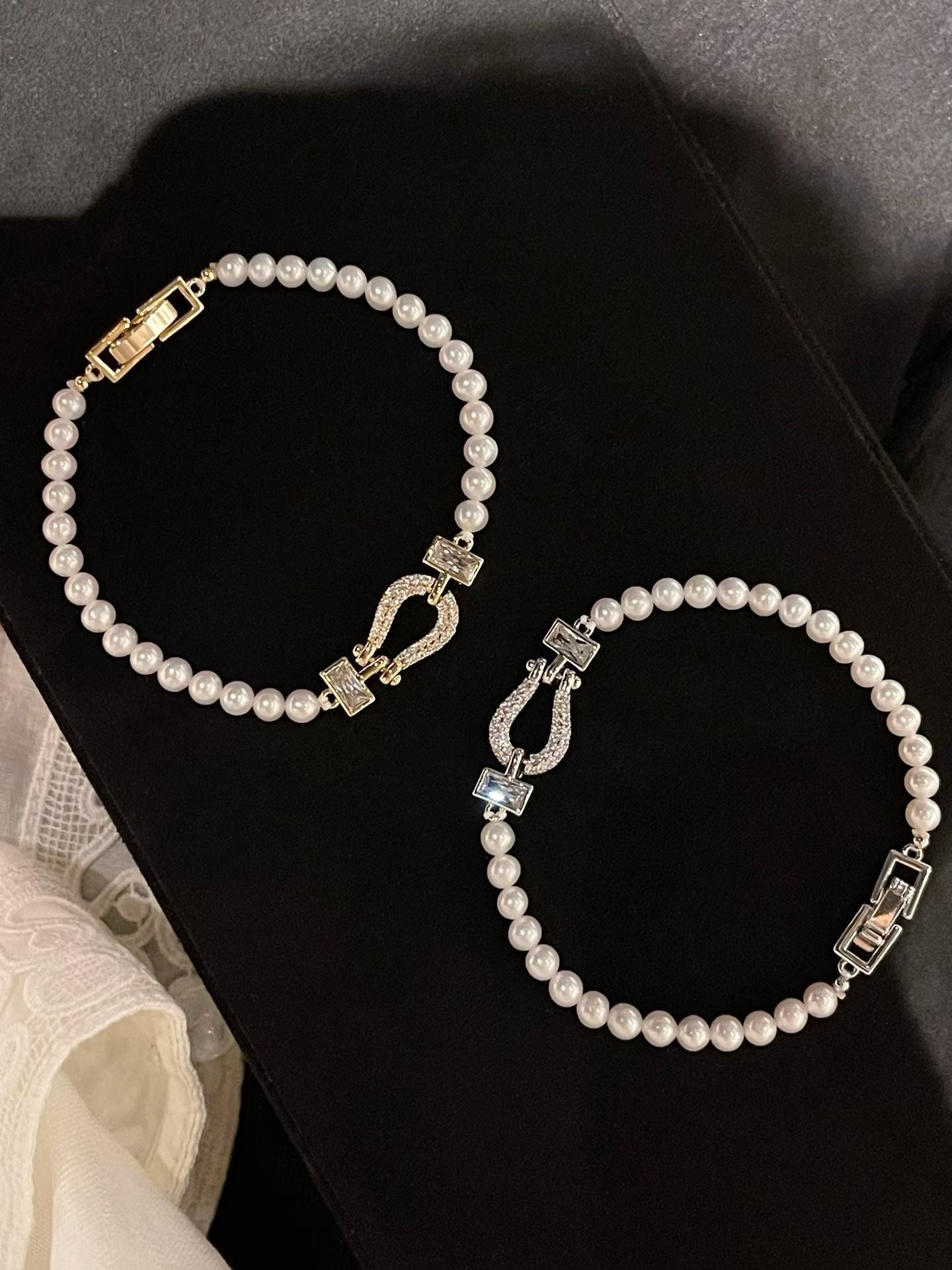 Freshwater pearl necklace and bracelet set on a black display board